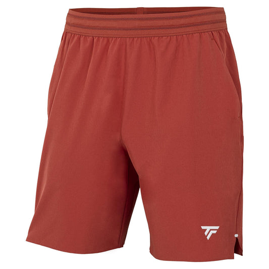 The Tecnifibre Team Stretch Mens Tennis Shorts in Terracotta feature an elastic waistband, side pockets, and a small white logo on the lower left leg. Lightweight and versatile, they’re perfect for both sports and casual wear.