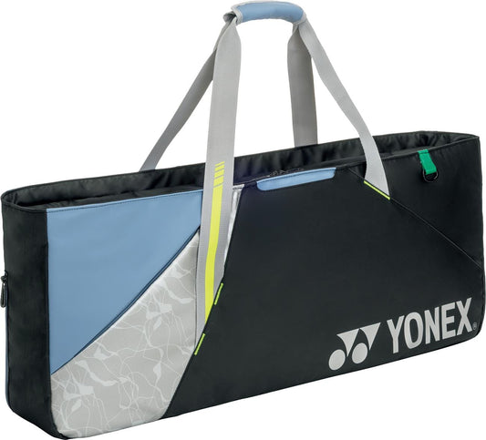 The Yonex BA52531EX Club Tournament Tennis Bag in Black/Blue by Yonex features a modern geometric design, two gray shoulder straps, and a padded handle.