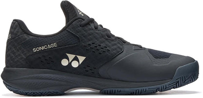 The Yonex Power Cushion Sonicage Men's Tennis Shoe in Black/Mocha Grey features a "SONICAGE" text, white Yonex logo, textured upper, lace-up design, and patterned sole—shown side view against a white background.