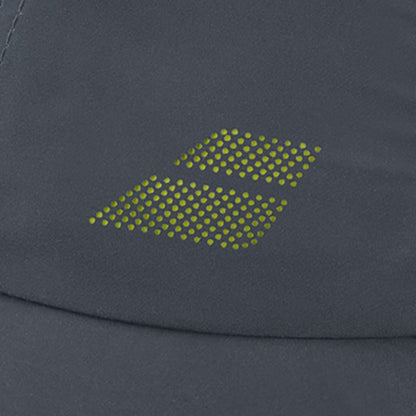 Close-up of the Babolat Aero Performance Tennis Cap in grey, featuring lightweight dark gray fabric with small yellow-green dots forming two overlapping diamond shapes, combining Babolat style with sun protection.