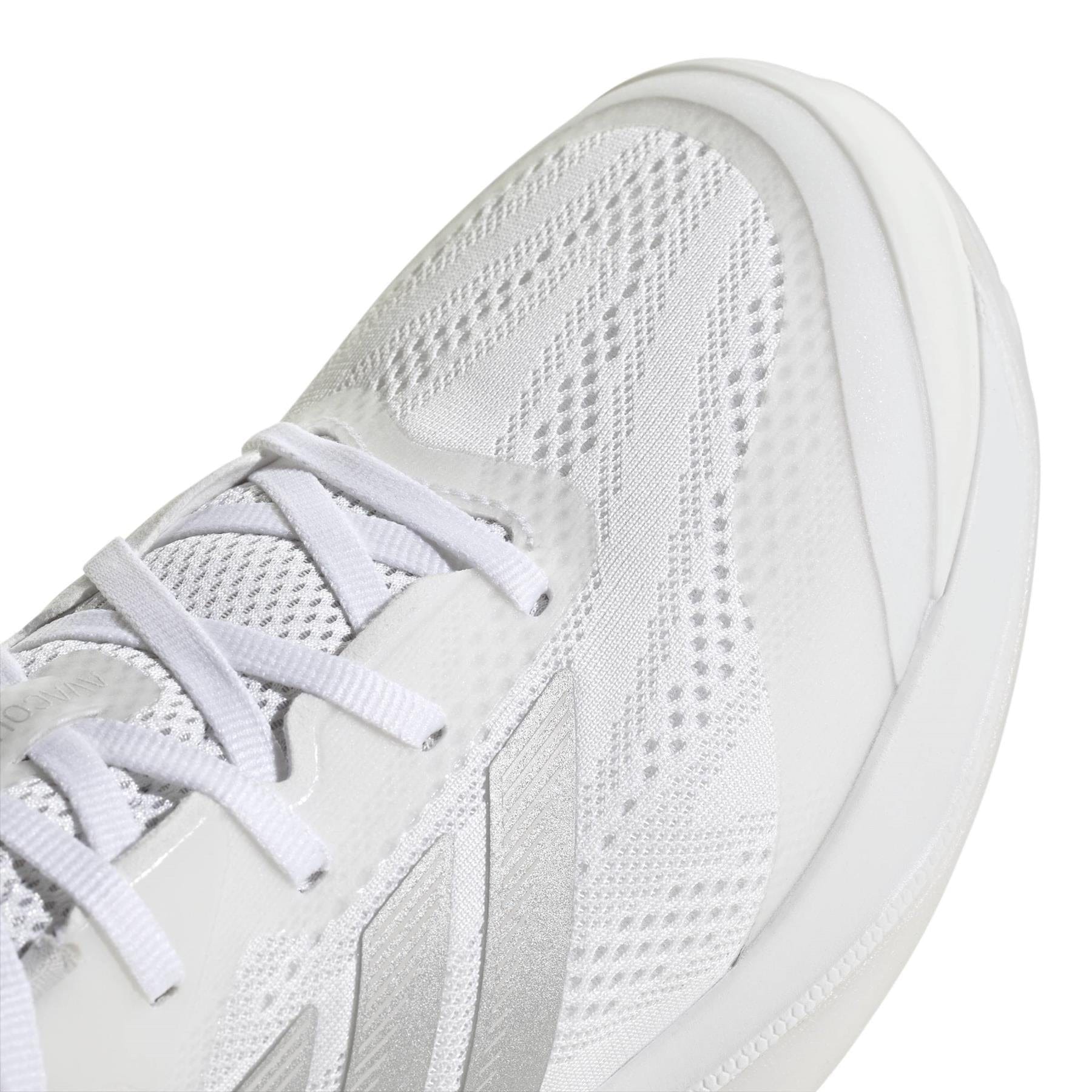 Close-up of the adidas ADIDAS Avacourt 3 Womens Tennis Shoes in white, featuring mesh and synthetic overlays for breathability and support, with white laces and textured fabric details—designed for women’s tennis courts.