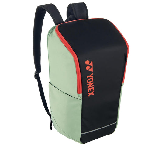 Presenting the Yonex 42312SEX Team Tennis Backpack in a sleek black and green color scheme with red accents. This stylish accessory is ideal for racket sports enthusiasts, featuring adjustable black straps, convenient side pockets, and a modern design. The iconic Yonex logo stands out prominently on its front panel.