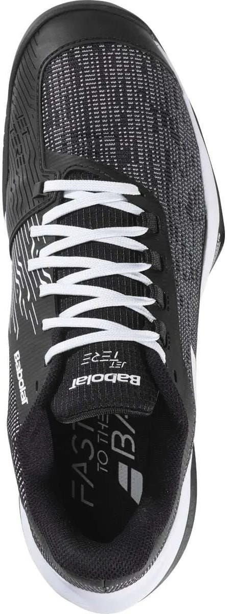 The Babolat Jet Tere 2 All Court Men's Tennis Shoes in black/white feature a lightweight, textured upper, white laces, breathable mesh details, "Babolat" branding on the side and tongue, and a cushioned black interior for comfort.