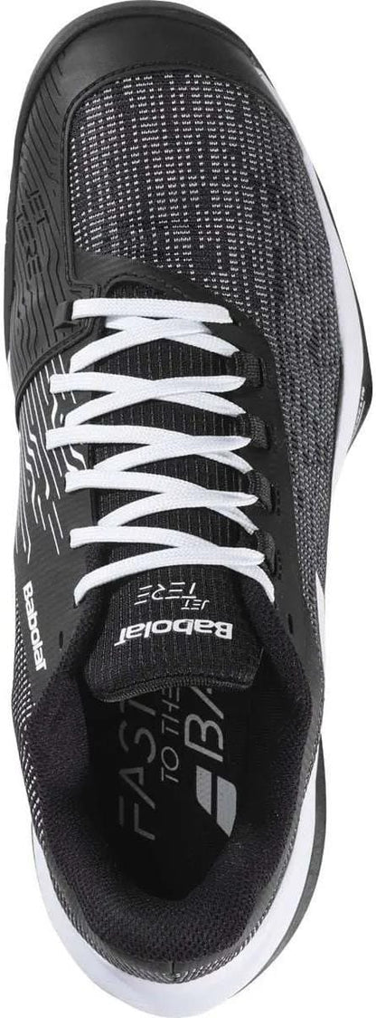 The Babolat Jet Tere 2 All Court Men's Tennis Shoes in black/white feature a lightweight, textured upper, white laces, breathable mesh details, "Babolat" branding on the side and tongue, and a cushioned black interior for comfort.