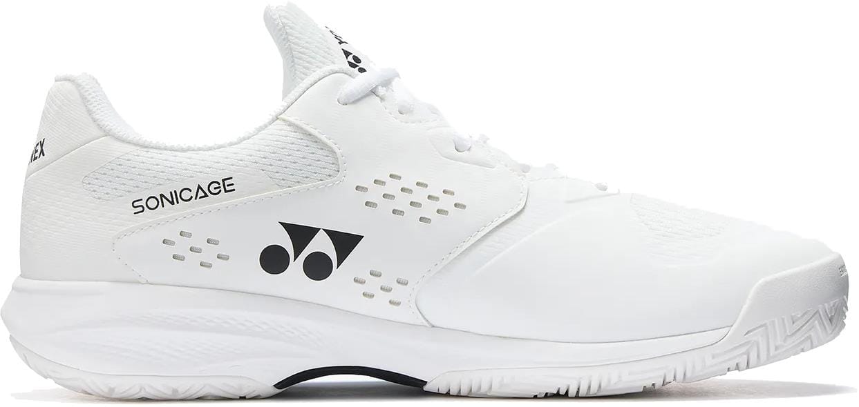 The Yonex Power Cushion Sonicage Wide Unisex Tennis Shoes in white are durable, lightweight, and breathable tennis shoes with a textured sole, featuring the Yonex logo and "SONICAGE" printed on the upper.