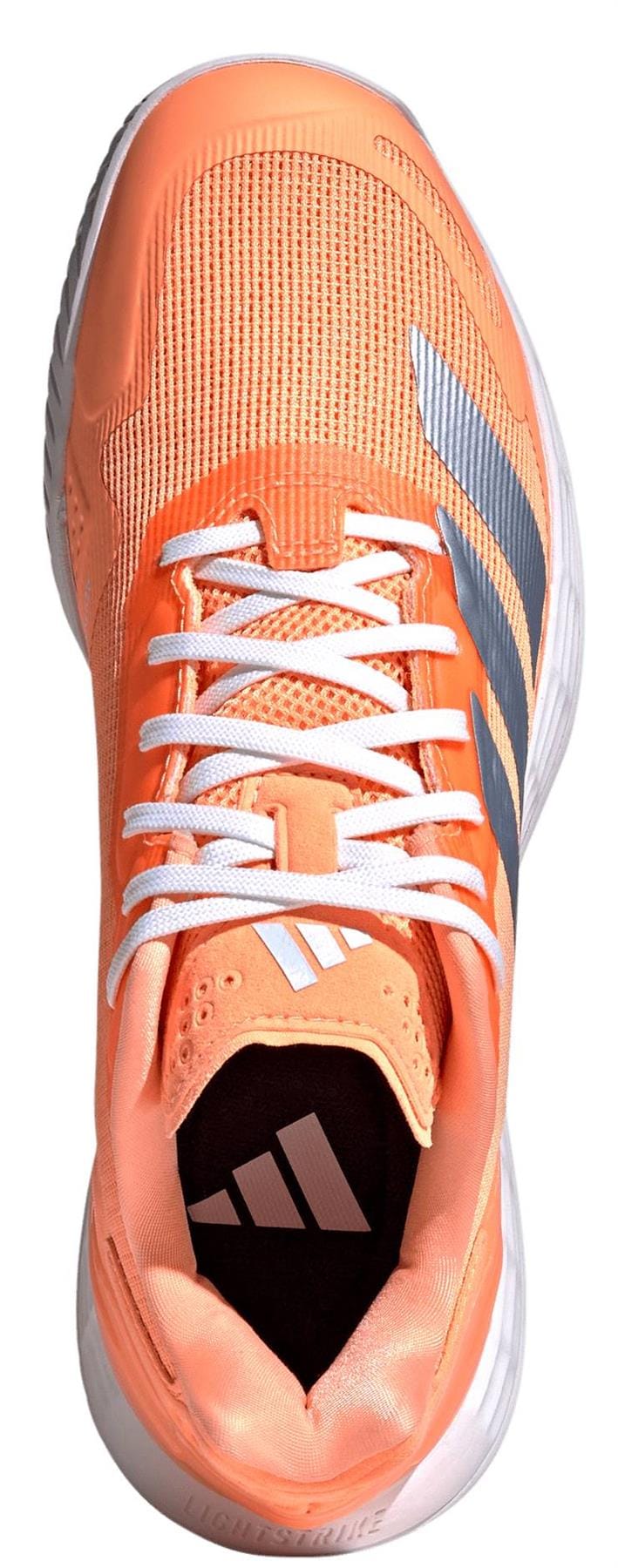 Top view of the adidas Defiant Speed 2 Womens Tennis Shoes in orange, featuring white laces, a mesh upper, white and silver adidas logo on the tongue, three dark side stripes, and a white sole.