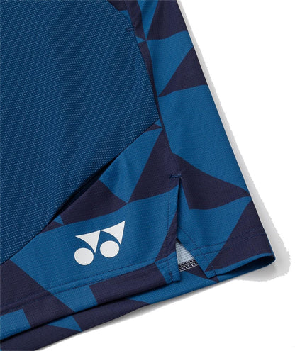 Close-up of Yonex 15240YX Knit Mens Tennis Shorts in indigo blue, made from breathable knit fabric with geometric dark blue patterns and a white Yonex logo near the vented hem.