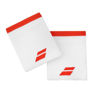 Two Babolat Logo Jumbo Wristbands in White / Fiesta Red, made from high-absorption terry material, showcase bold red edges and logos. They are elegantly laid flat on a white background.