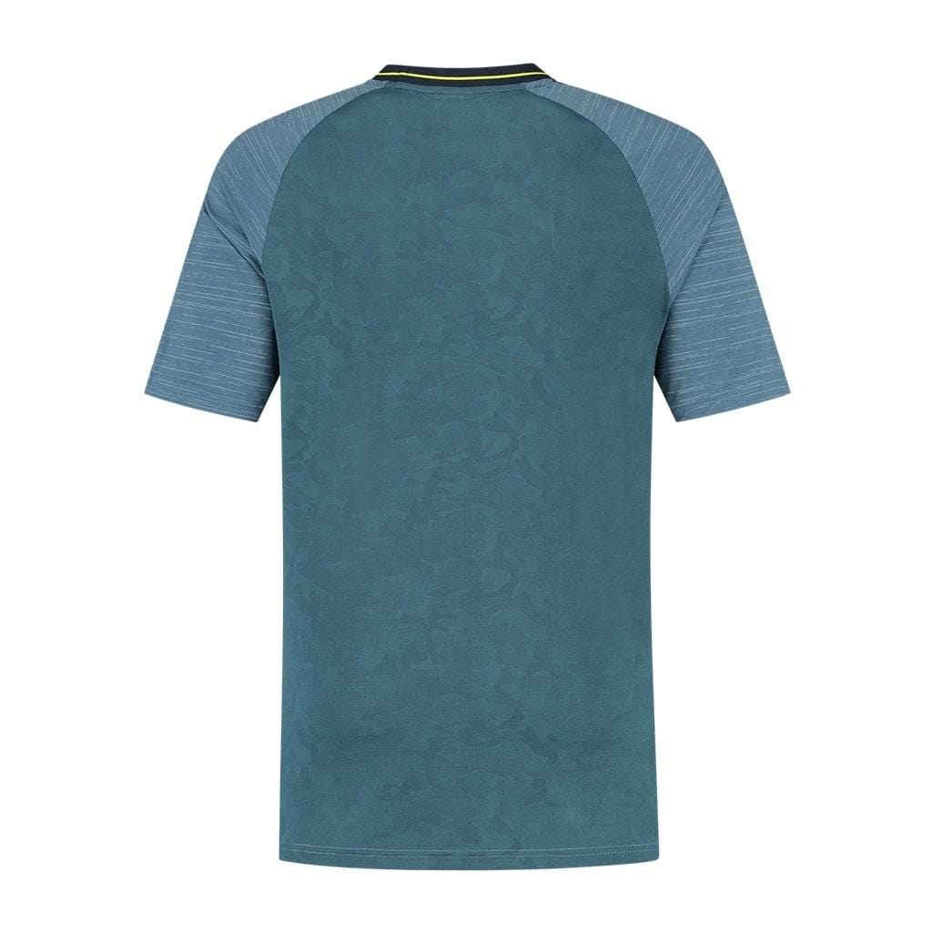 The image showcases the K-Swiss Hypercourt Melange 2 Men's Tennis T-Shirt in Indian Teal, featuring a back view of the short-sleeved jersey made from breathable polyester. The upper sleeves are light gray with a subtle stripe pattern, while the main teal section displays a faint camouflage design. A small yellow detail enhances the collar, emphasizing its high-performance quality.
