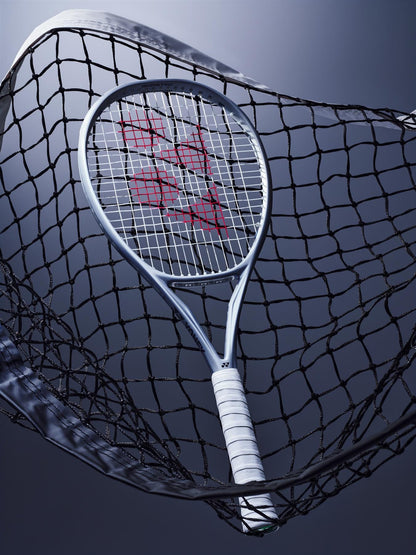 The Yonex Muse 100 Tennis Racket by Yonex, featuring a white grip and red-patterned strings, rests tangled in a net against a dark blue gradient background.