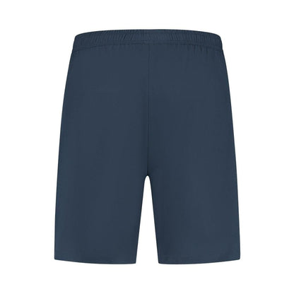 The K-Swiss Hypercourt Men's 7 Inch Tennis Shorts in Peacoat feature deep pockets and an elastic waistband, showcased against a white background. These shorts boast a simple design with 4-way stretch for ultimate comfort and flexibility, all without any visible logos or embellishments.