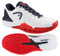 A pair of HEAD Revolt Pro 5.0 Men’s Tennis Shoes by HEAD in White/Navy; one shoe is shown from the side, the other displays its patterned sole—perfect for baseline players seeking style and performance.