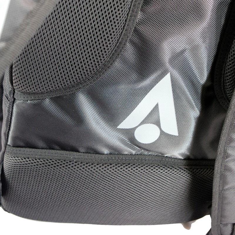 The Karakal Pro Tour 30 2.1 Tennis Backpack - Black / Blue is highlighted in a close-up view, showcasing its black fabric and mesh pockets. It comes with padded shoulder straps for added comfort and features a stylized white logo with an upward arrow shape and dot on the side panel, all within its roomy 30-litre capacity design.