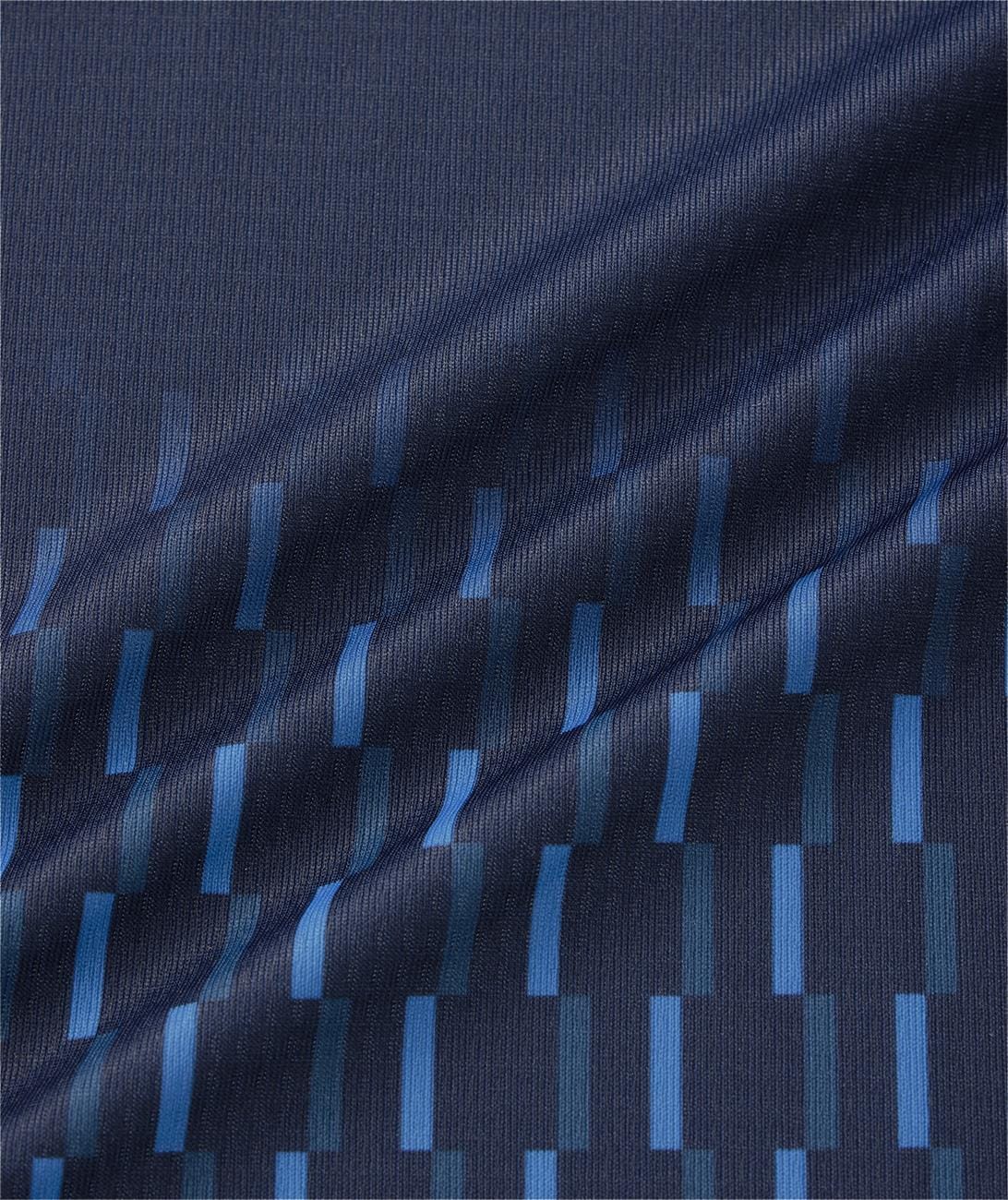 A close-up of the Yonex 10713EX Crew Neck Men's Tennis T-Shirt in dark navy shows geometric blue and teal rectangles in staggered rows. The moisture-managing fabric features a gentle diagonal fold, perfect for tennis performance.