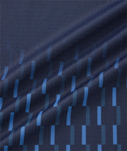 A close-up of the Yonex 10713EX Crew Neck Men's Tennis T-Shirt in dark navy shows geometric blue and teal rectangles in staggered rows. The moisture-managing fabric features a gentle diagonal fold, perfect for tennis performance.