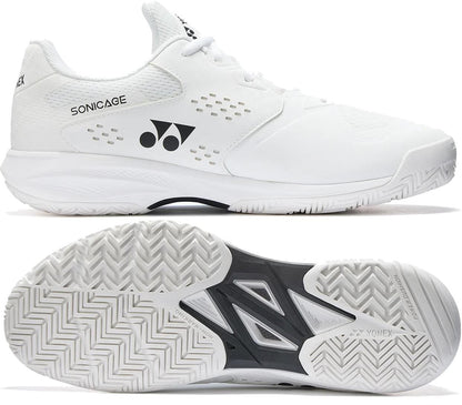 A pair of white Yonex Power Cushion Sonicage Wide Unisex Tennis Shoes, shown from the side and bottom. The side view highlights the "Sonicage" label and Yonex logo; the sole features a herringbone grip and Yonex branding.