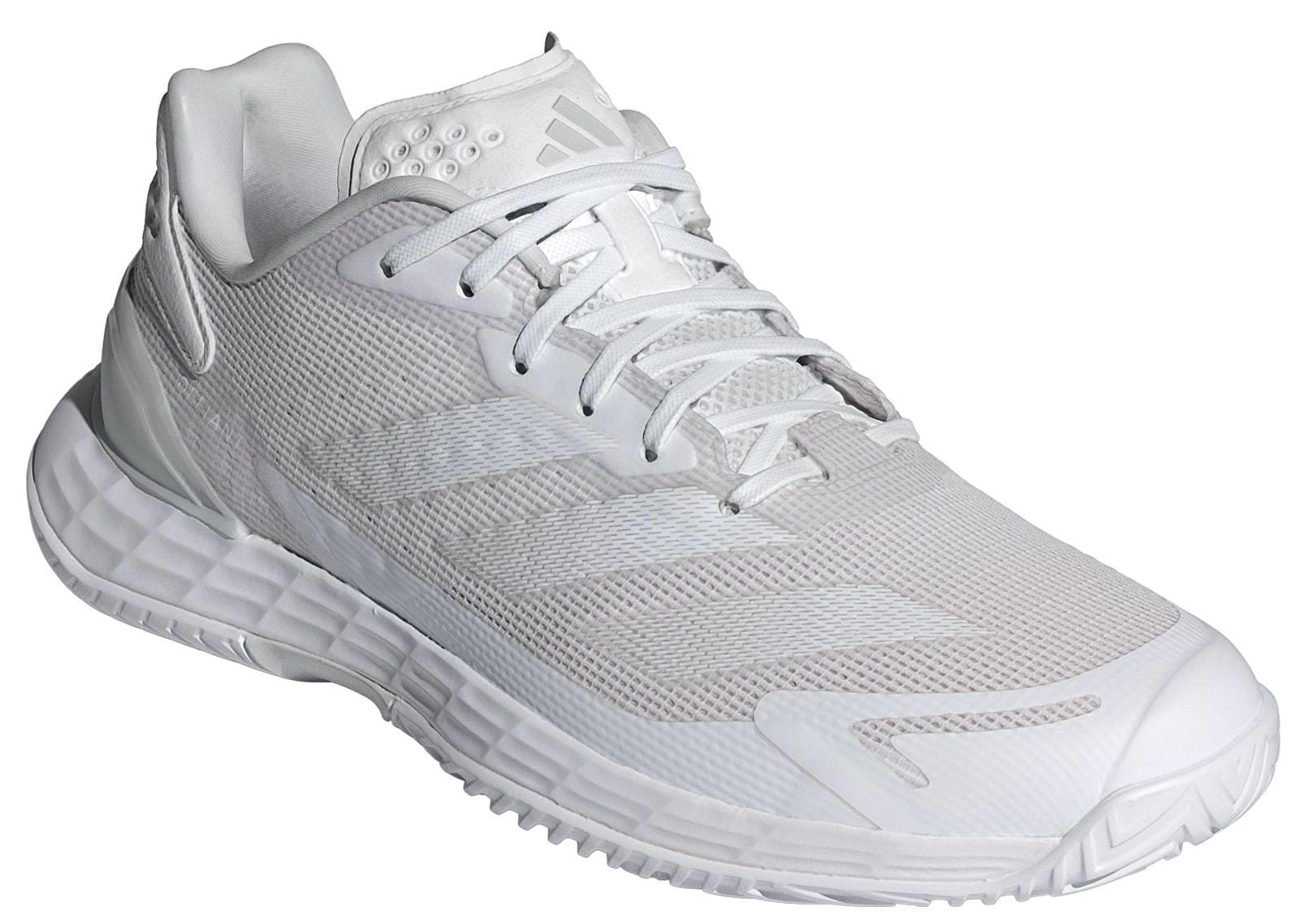 The ADIDAS Defiant Speed 2 Womens Tennis Shoes in white feature mesh uppers, a lace-up closure, and a textured sole—lightweight and perfect for women who want style and performance on the court.