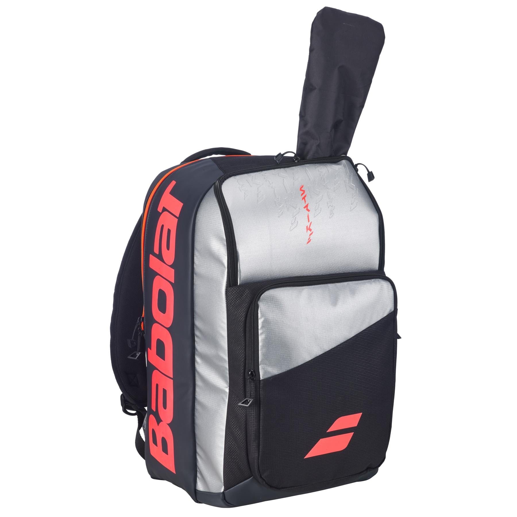 The Babolat Pure Strike Tennis Backpack - Carbon Grey features gray, black, and red accents, a visible tennis racquet in the rear compartment, multiple zippered pockets, and a large Babolat logo on the side.