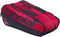 The Babolat Court L 9 Racket Tennis Bag in Burgundy and Black is crafted from recycled polyester and features a large logo, multiple zippered compartments, and convenient handles—designed to carry racquets and sports gear.
