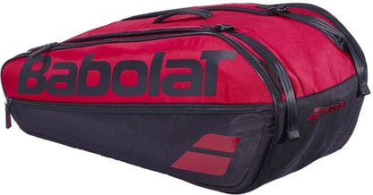 The Babolat Court L 9 Racket Tennis Bag in Burgundy and Black features a prominent logo, multiple zippered compartments, and convenient carry handles, making it ideal for transporting rackets and gear. Crafted from durable recycled polyester, this eco-friendly bag is a reliable choice for tennis players.