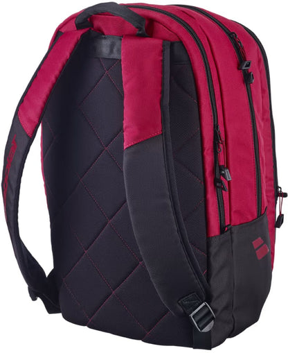 Babolat Court Hero Tennis Backpack in burgundy and black features a quilted back panel, padded shoulder straps, multiple zip compartments, and a bottom chest strap clip—crafted by Babolat from recycled polyester for both style and sustainability.