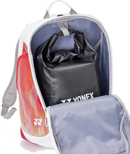The Yonex 02612EX Expert Tennis Backpack in white is unzipped, revealing a spacious gray interior with a black Yonex bag inside. The open front flap showcases the roomy compartment and organized storage.
