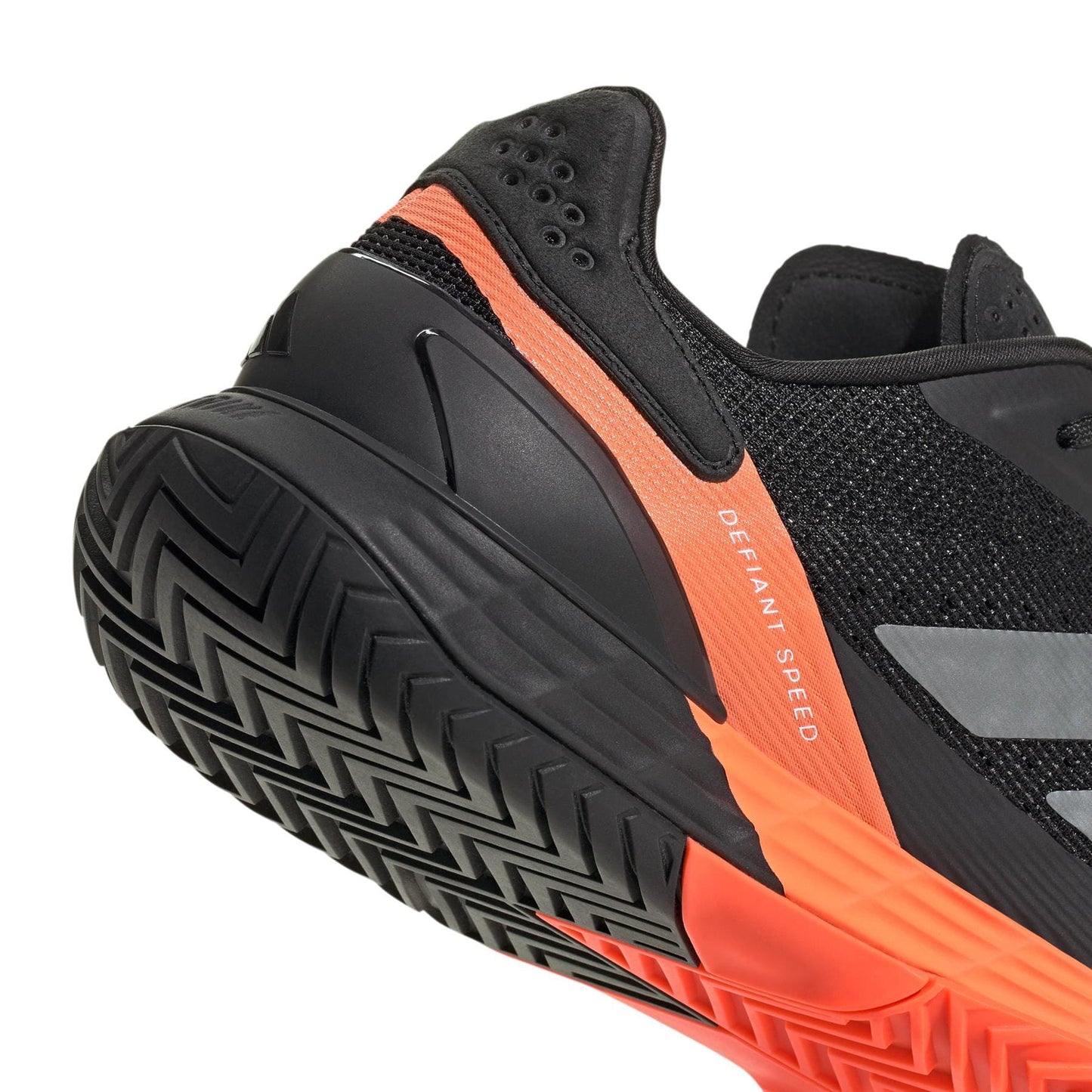 Close-up of the heel and sole of adidas Defiant Speed 2 Men's Tennis Shoes in black and orange, showing a textured sole, mesh upper, and "Defiant Speed" printed on the side. Lightweight design by adidas.