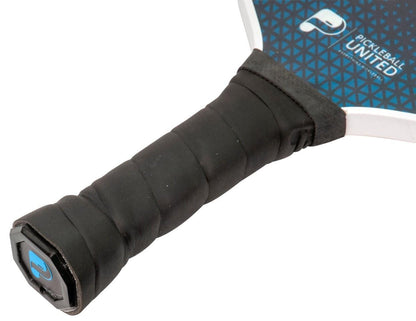 Close-up of the Pickleball United Freedom Pickleball Paddle handle wrapped in black grip tape, showing part of the blue and black fiberglass surface with the Pickleball United logo.