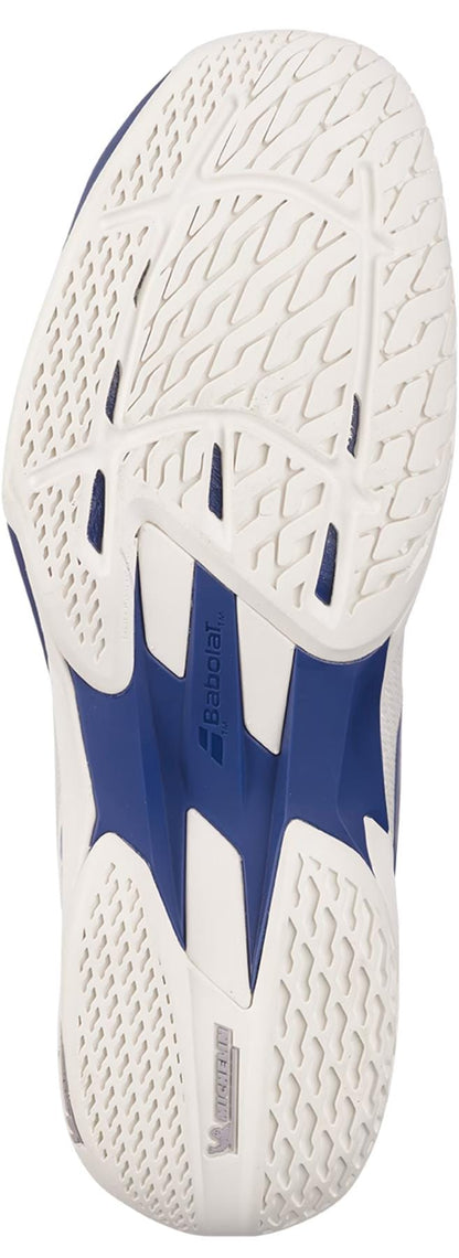 Close-up of the white and blue sole on the Babolat Jet Mach 4 All Court Men's Tennis Shoes in Cream/Dark Blue, showing intricate tread, ventilation holes, and both Babolat and Michelin logos near the heel.
