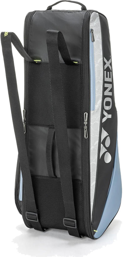 The Yonex BA52526EX Club 6 Racket Tennis Bag in black/blue features backpack straps, mesh side pockets, zippered racket compartments, and a vertical Yonex logo—a durable bag for every match.
