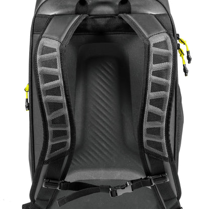 Close-up of the Tecnifibre Reform Tennis Backpack - Black’s back panel with padded mesh shoulder straps, a yellow zipper pull on the right, and a chest strap clipped at the bottom. Brand: Tecnifibre.