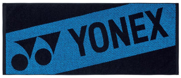The Yonex AC1113EX Tennis Sports Towel in black features a blue diagonal stripe, bold Yonex logo and name, and is made from 100% cotton.