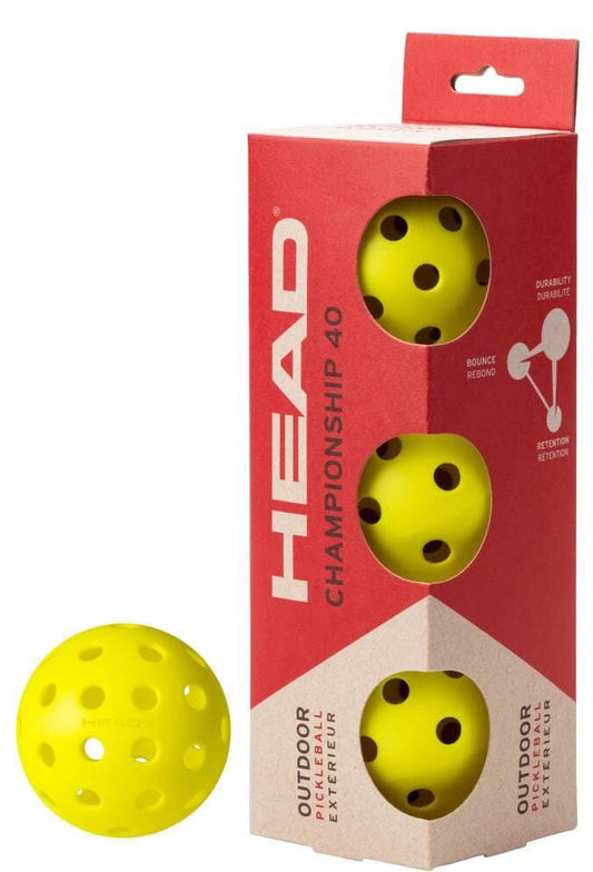 A HEAD Championship 40 Outdoor Pickleball Balls (3 Ball) box from HEAD holds three yellow balls, with one identical outdoor pickleball beside it.
