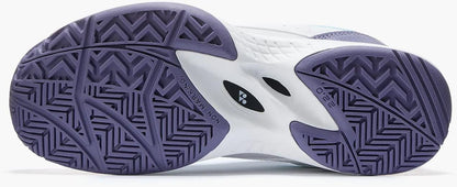 The image displays the sole of Yonex Pro-Move Classic Junior Tennis Shoes - White / Sax, featuring zigzag and herringbone tread patterns for grip and traction, plus Power Cushion Technology for added comfort and shock absorption.