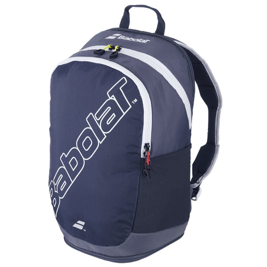 The Babolat Evo Court Tennis Backpack in grey and blue boasts a large front pocket, a smaller zippered top compartment, and dedicated racket storage. The brand logo stands out prominently in white on the front. Crafted from eco-friendly material, it features adjustable straps and a top handle for easy carrying.