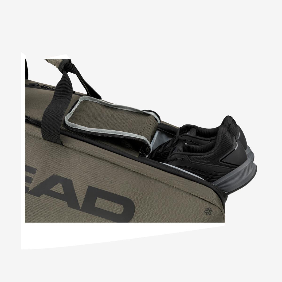 A close-up of the HEAD Pro X Tennis Bag L - TYBK in brown showcases the word "HEAD" on its side. This bag incorporates CCT+ Climate Control Technology and is partially open to reveal a pair of black shoes inside. It features black handles and a shoulder strap for convenient carrying.
