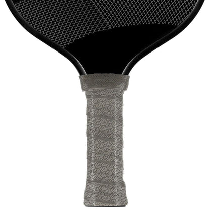 Close-up of a Lizard Skin DSP Ultra Pickleball Grip 0.8mm in Graphite Grey, showing its textured non-slip finish wrapped on the handle of a black paddle with a visible string pattern above the grip.