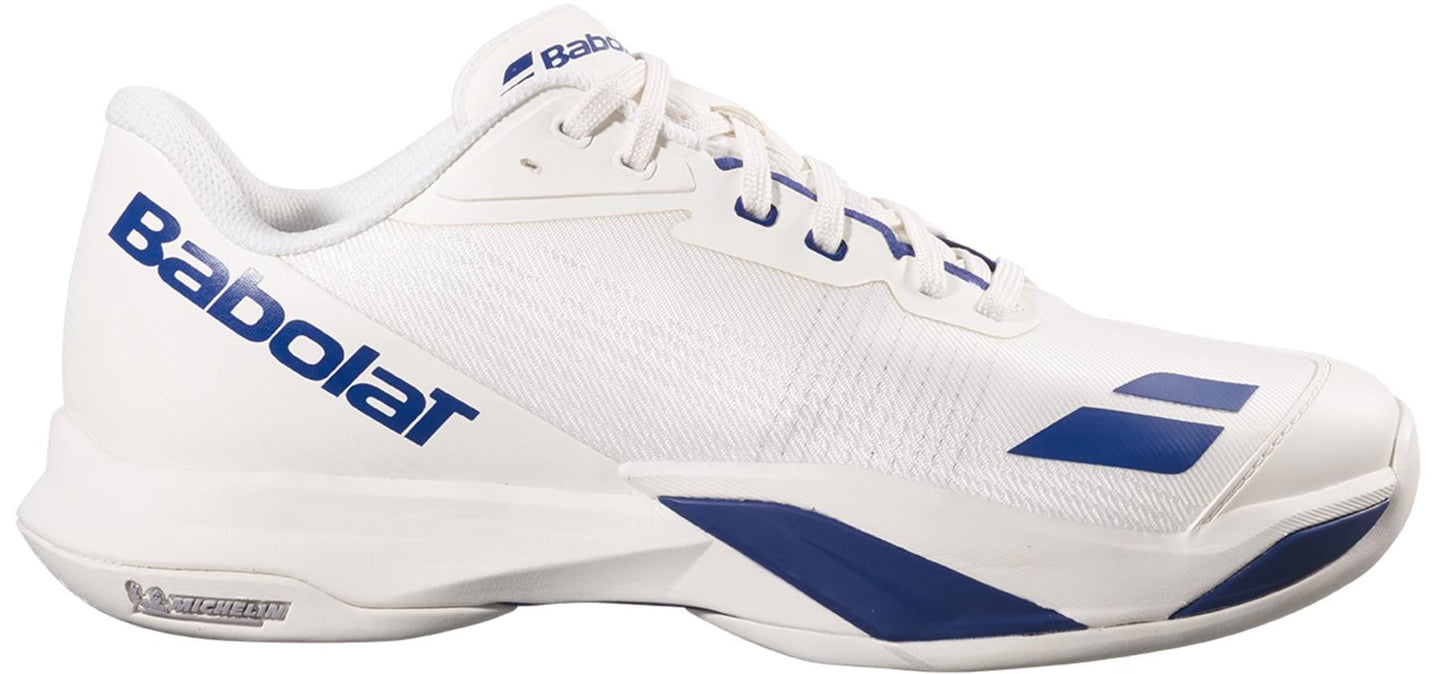 The Babolat Jet Mach 4 All Court Men's Tennis Shoes in cream and dark blue feature a low-cut design, lace-up closure, Babolat logo on the side, and a Michelin rubber sole for agile performance on the court.