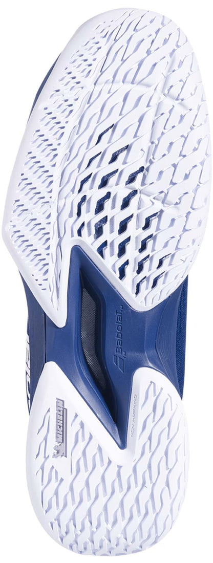 The image shows the sole of the Babolat Jet Tere 2 Premium All Court Men's Tennis Shoe in dark blue, featuring intricate tread patterns for grip and a visible "Michelin" logo, highlighting durable rubber technology. The "Babolat" brand is also shown.
