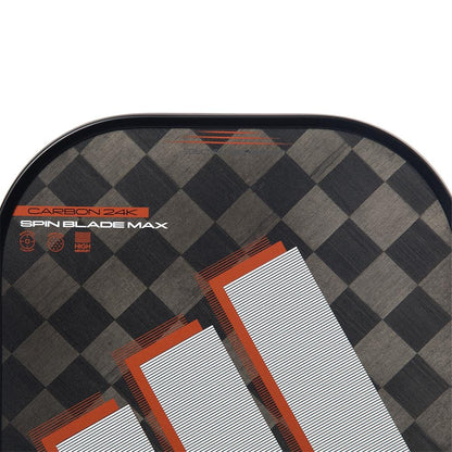 Close-up of the adidas ADIDAS Adipower CTRL 3.3 Pickleball Paddle - Black / Orange, featuring a black and gray checkered pattern, bold white/orange stripes, "CARBON 24K," "SPIN BLADE MAX," and icons highlighting its 24K aluminized carbon surface.