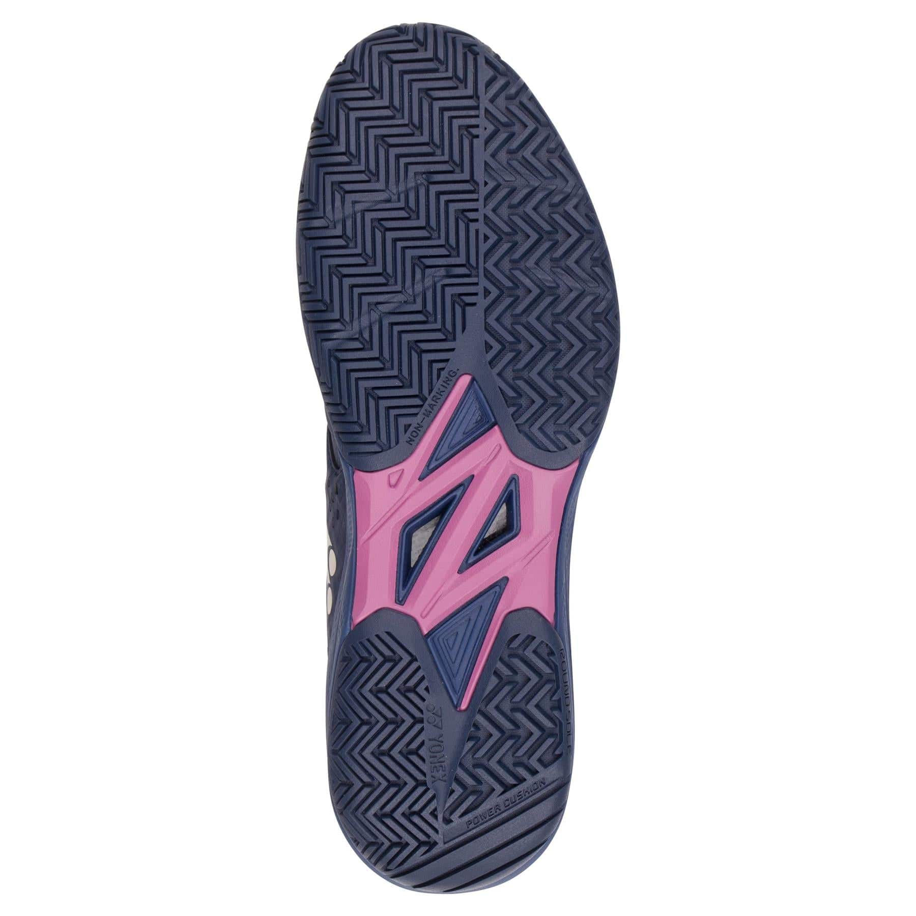The Yonex Power Cushion Sonicage Wide Tennis Shoes in Dark Navy feature a zigzag herringbone sole and a pink midsection with geometric cutouts, making them an ideal lightweight option for tennis players.