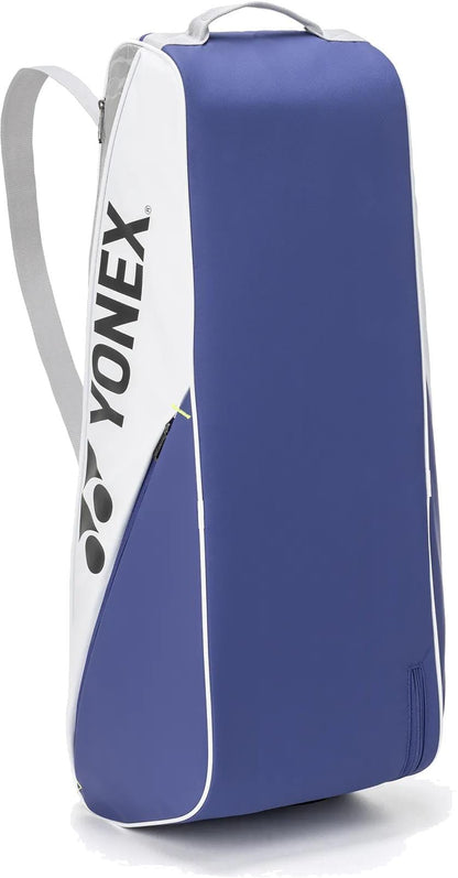 The Yonex BA52526EX Club 6 Racket Tennis Bag in white and blue features a shoulder strap and Yonex branding, offering a durable and stylish way to carry your gear.