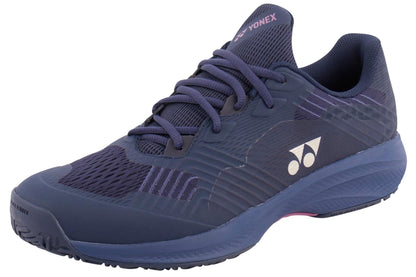 A Yonex Power Cushion Sonicage Wide Tennis Shoe in dark navy with purple accents, a white Yonex logo on the side, textured sole, and dark laces, shown from a front-side angle against a white background.