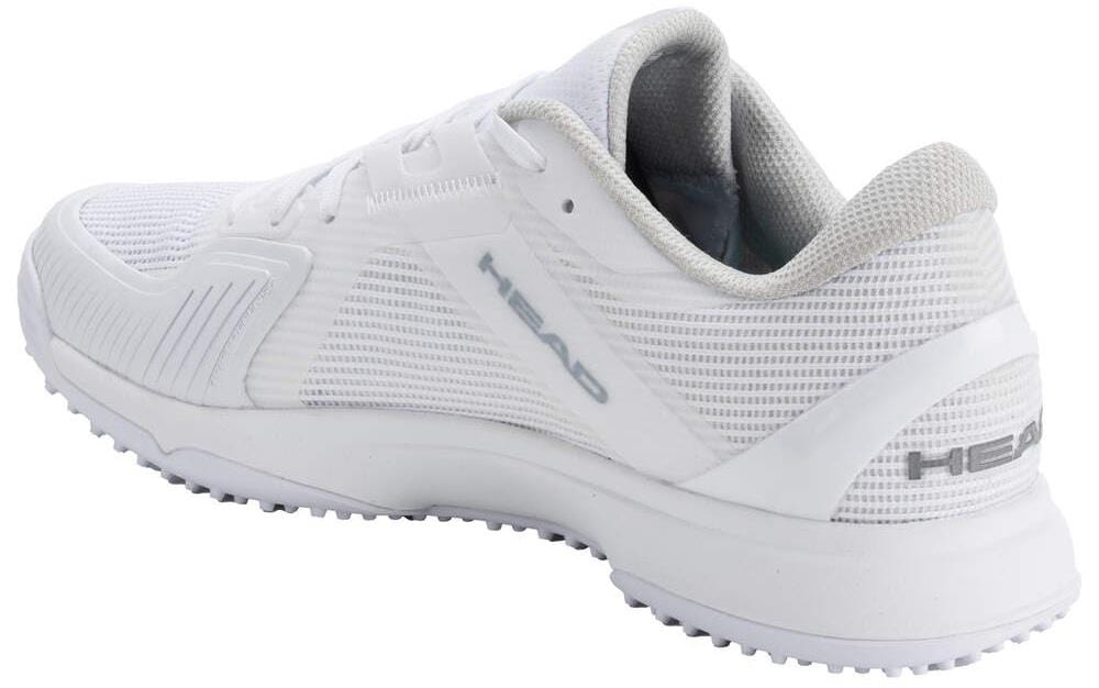 The HEAD Sprint Pro 4.0 Women's Grass Court Tennis Shoes in White/Grey feature a lightweight, breathable design and textured sole, with "HEAD" branding on the side and heel, displayed at a rear-side angle on a white background.