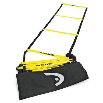 The HEAD Agility Ladder, featuring yellow rungs and black straps, is partially extended across a surface, ready to enhance footwork drills, with a convenient black carrying bag nearby.
