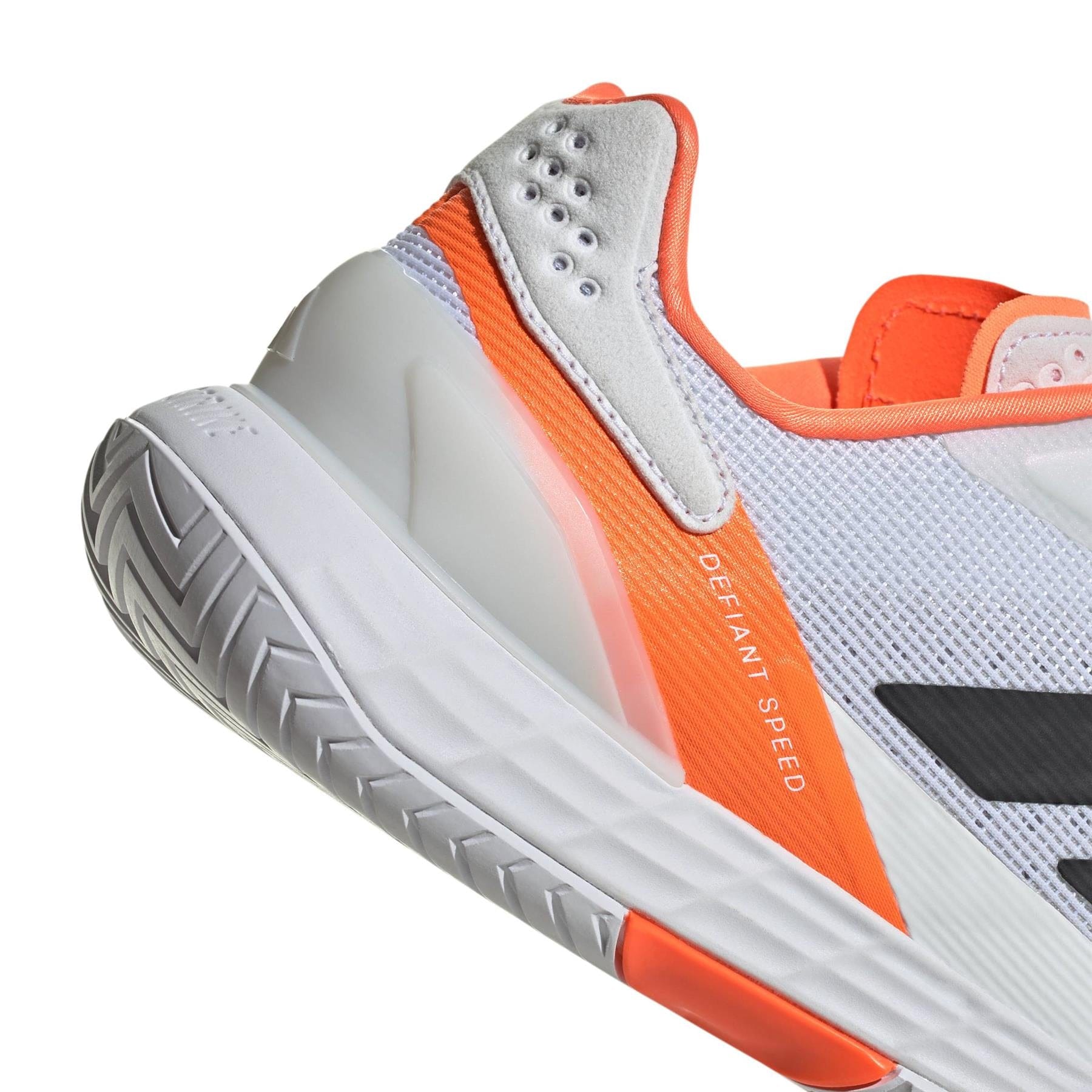 Close-up of the adidas Defiant Speed 2 Men's Tennis Shoes in White/Orange, featuring a mesh upper, white sole, and orange and grey accents—designed for men's tennis with "DEFIANT SPEED" printed on the side.