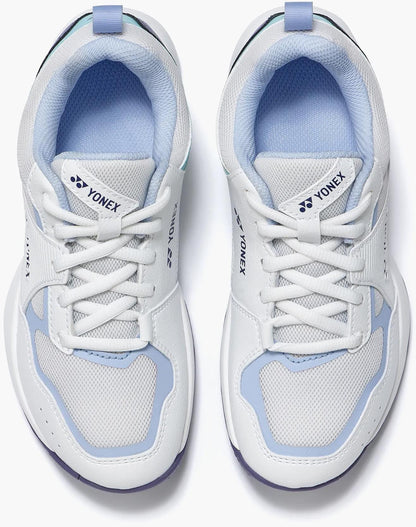 A pair of Yonex Pro-Move Classic Junior Tennis Shoes in White/Sax with breathable mesh panels, white laces, and Power Cushion Technology, shown from above on a plain background.