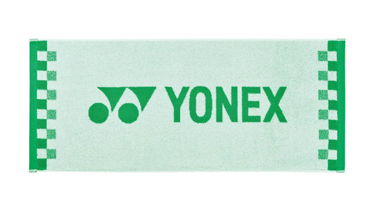 A white Yonex AC1109EX Face Towel featuring a checkered pattern along the edges, crafted from premium cotton. The green Yonex logo and name are prominently displayed at the center, making it an ideal workout towel for sports enthusiasts.