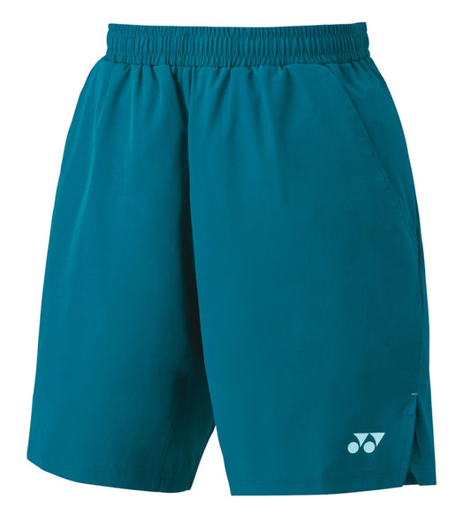 These Yonex 15161EX Men's Tennis Shorts in blue-green are equipped with VeryCool technology for optimal comfort. They feature an elastic waistband, side pockets, and a discreet white logo on the lower left leg, combining style and performance.