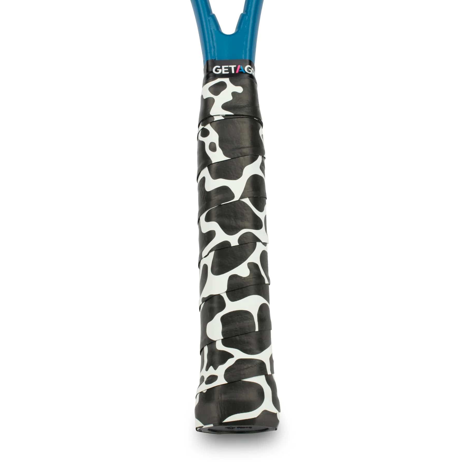 A detailed view of a tennis racket grip showcases the white and black camouflage design of the Get A Grip Cow-A-Bunga Tennis Overgrip. Crafted from premium materials for enhanced durability, this non-slip overgrip prominently displays "Get A Grip" at the top. The shaft of the racket is blue.